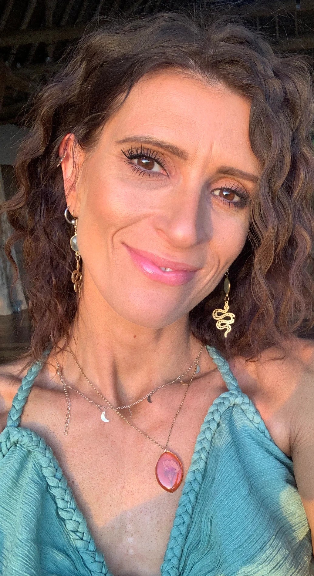 Pattie Papa smiling at the camera on a covered wooden deck